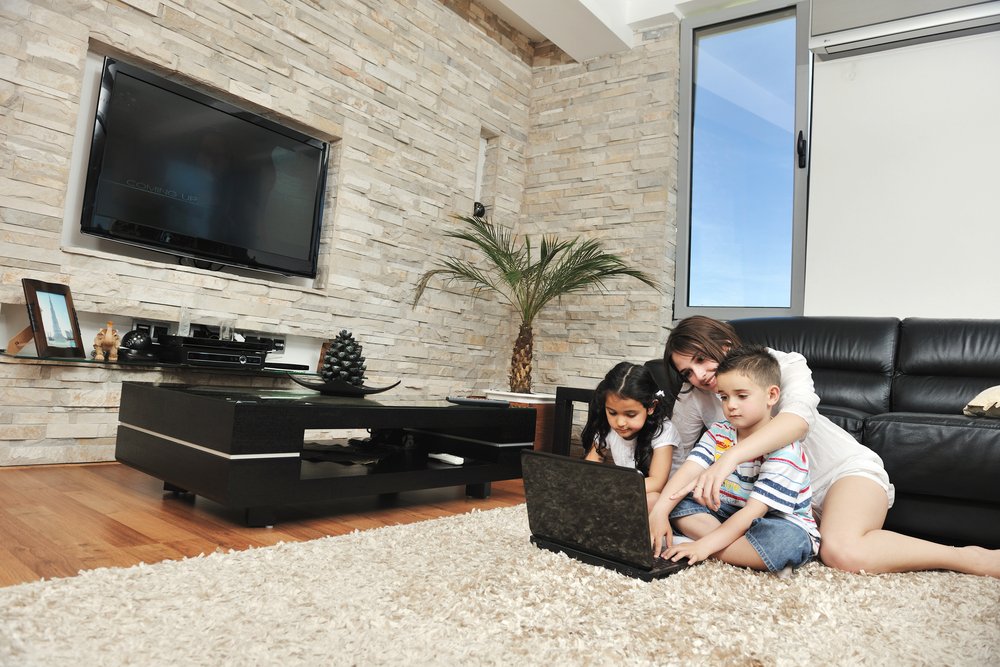 happy young family have fun and working on laptop at modern  home livingroom indoor